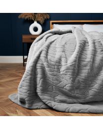 Bergen Embossed Faux Fur Throw in Grey styled on a bed