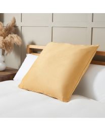 Large Velour Piped Cushion, Ochre on bed