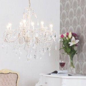 chandelier in room with wine glass and flowers