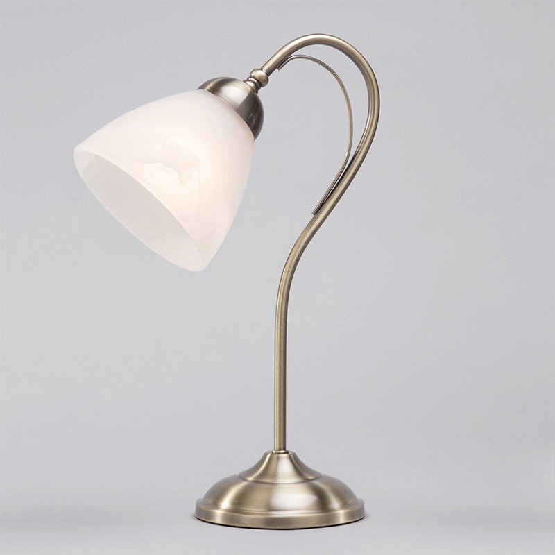 Barcelonadesk lamp antique brass, plain grey backdrop